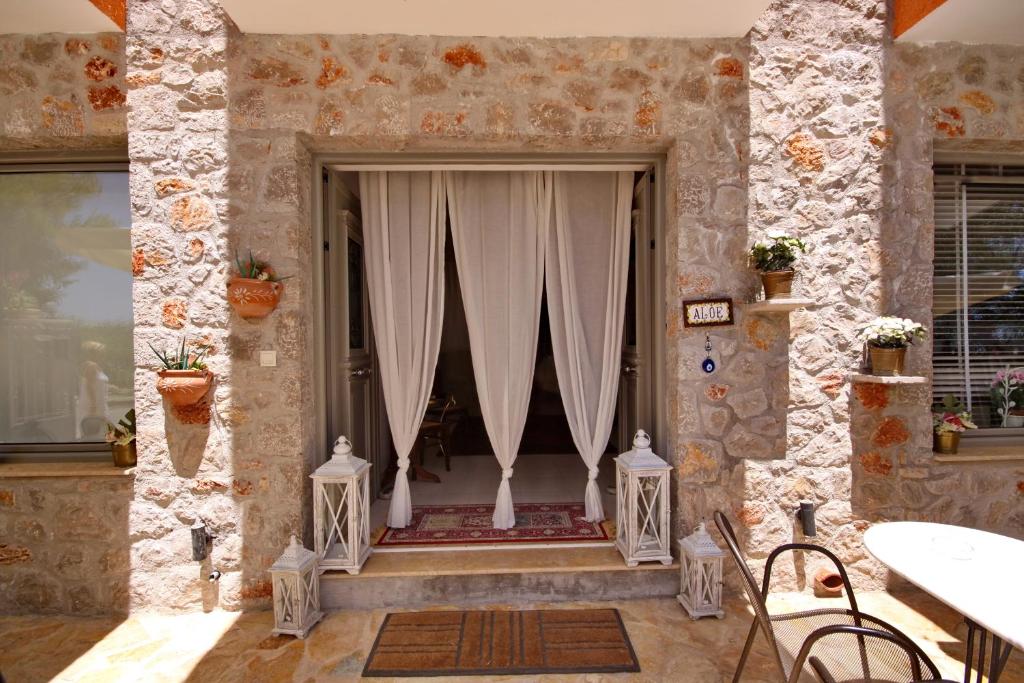 a room with a window with white curtains at Aloe Luxury Apartments in Porto Heli