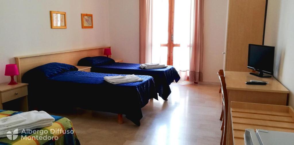 Hotel Diffuso Montedoro tesisinde bir odada yatak veya yataklar