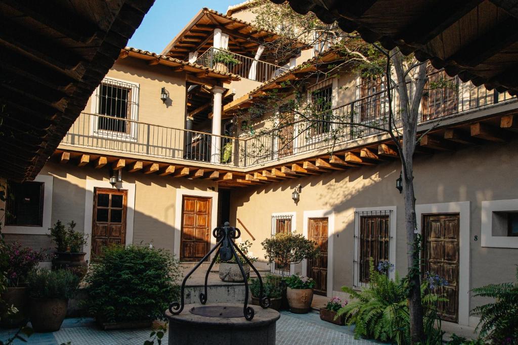 a building with a bench in front of it at Doña Francisca Hotel Boutique in Talpa de Allende