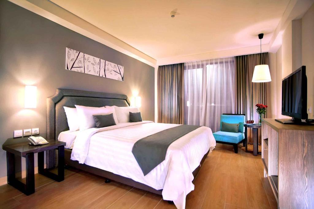 Postel nebo postele na pokoji v ubytování Harper Kuta Hotel by ASTON
