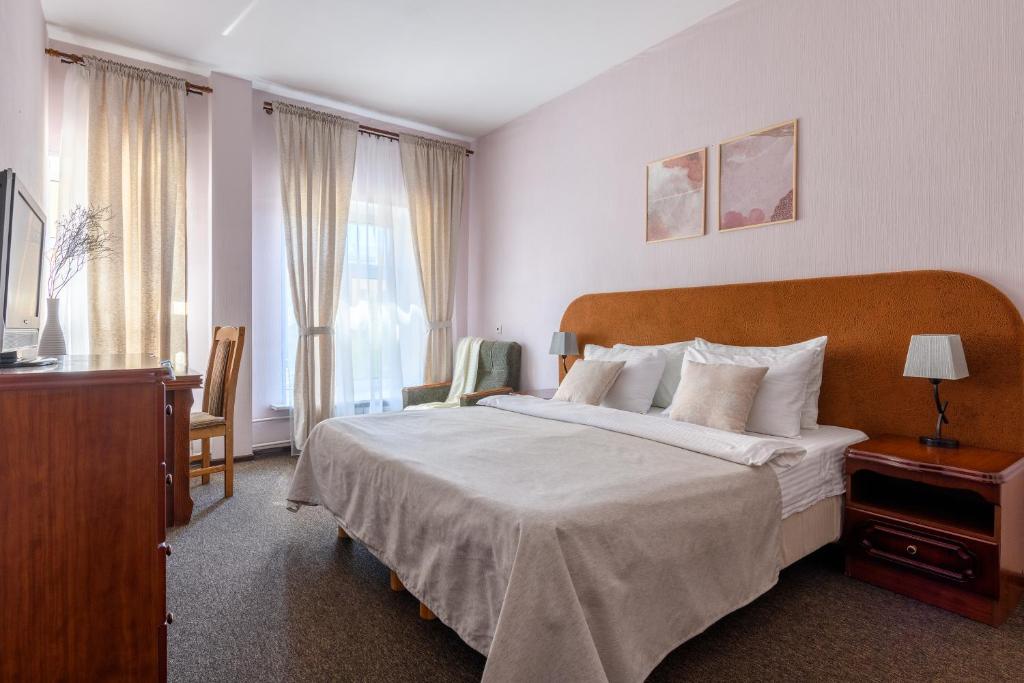Ein Bett oder Betten in einem Zimmer der Unterkunft Prestige na Vasilievskom