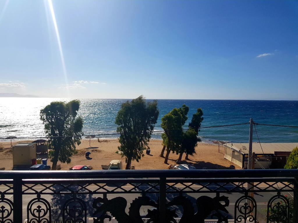 a view of the beach from a balcony at Aphrodite's Apartments in Artemida