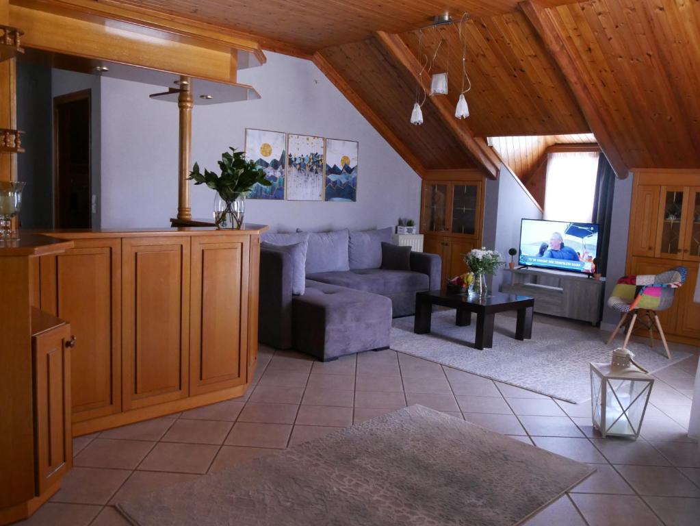 a living room with a couch and a tv at D&K Studio in Myrina