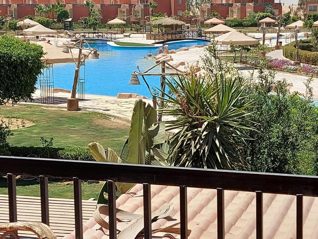 a balcony with a view of a swimming pool at Marina Wadi Degla Villa Duplex 4 Bedrooms in Ain Sokhna