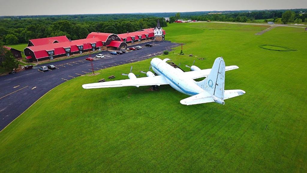 een vliegtuig zit op het gras in een veld bij Don Q Inn in Dodgeville