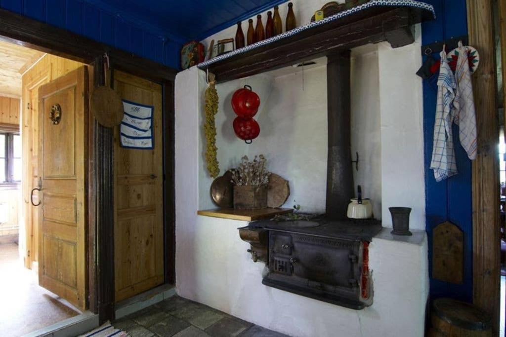 a room with an old wood stove on the wall at Ett hus för romantisk semester in Lammhult