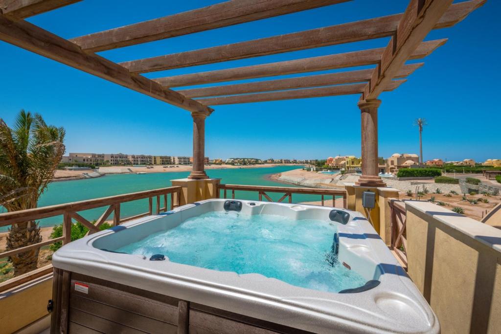 a hot tub on a deck with a view of the water at Scenic Views 3 bedroom Villa with private jacuzzi in Sabina in Hurghada