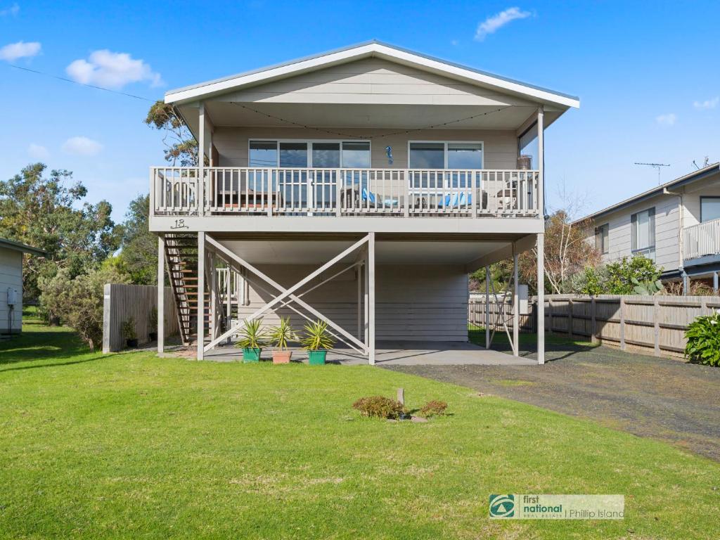 a house with a deck and a yard at 13 Seacombe Grove in Ventnor