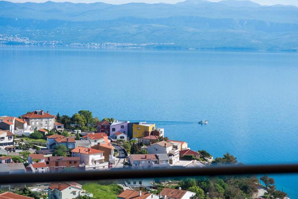 a town on the shore of a large body of water at Apartman Zoe Vrbnik in Vrbnik