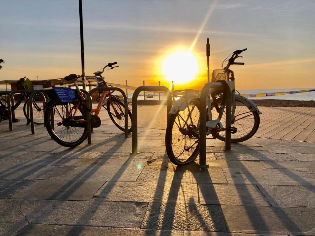 a group of bikes parked in front of the beach at Barceloneta Ramblas Apartments in Barcelona