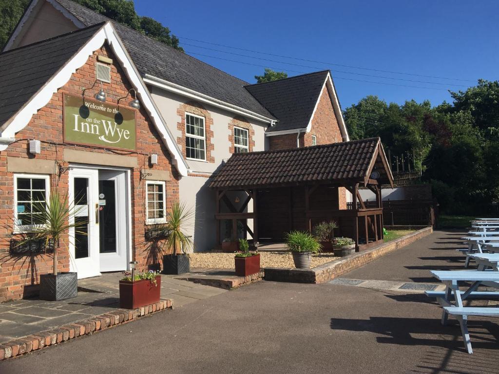 a pub with tables and tables in front of it at Inn On The Wye in Ross on Wye