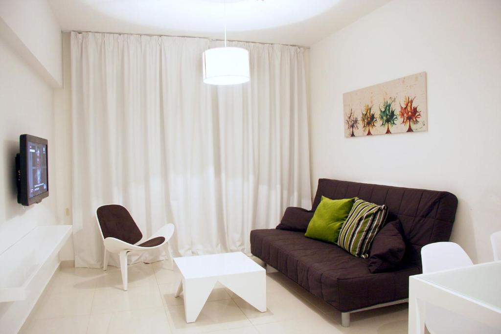 a living room with a couch and a chair at Mon Repos Hotel in Ayia Napa