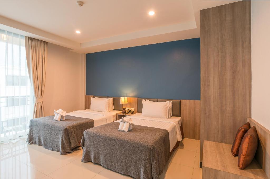 Postel nebo postele na pokoji v ubytování Lada Krabi Residence Hotel - SHA Plus