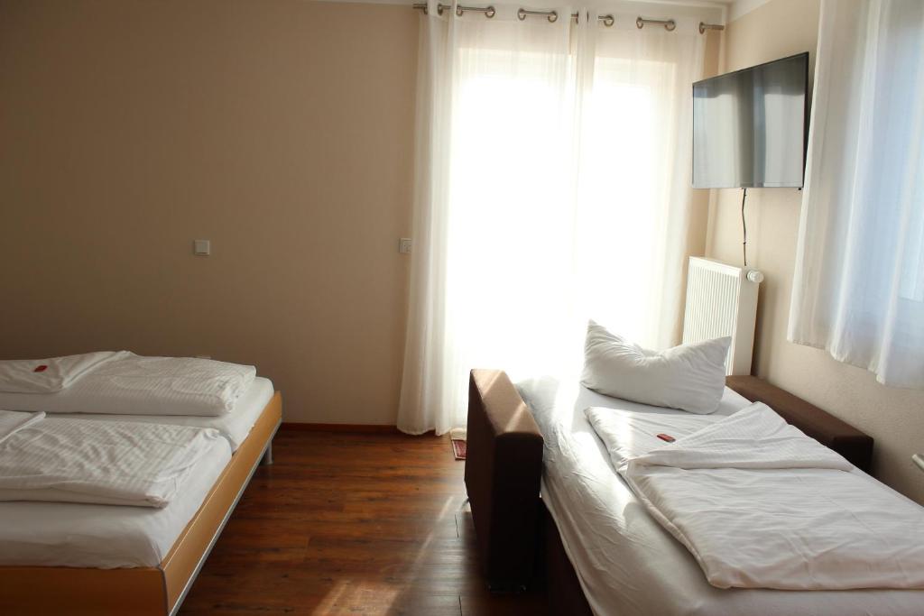 Postel nebo postele na pokoji v ubytování Hotel Alex