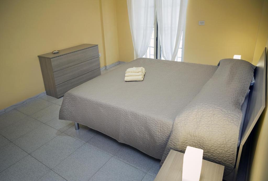 a bedroom with a bed with two towels on it at STANZA EUCALIPTO in Caserta