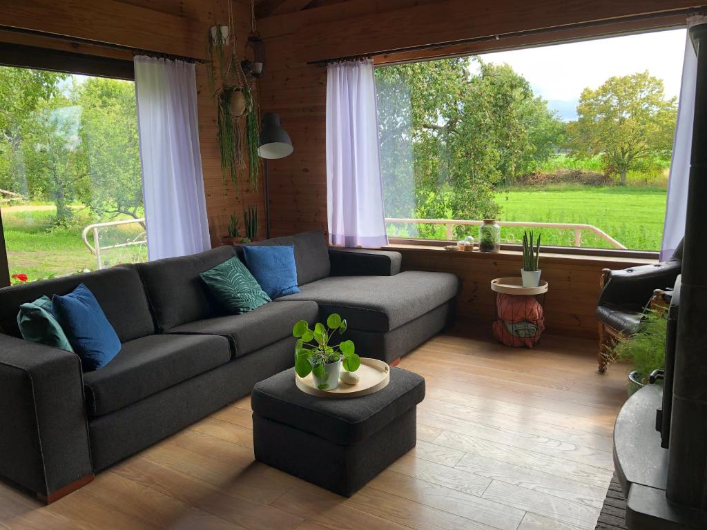 salon z kanapą i dużym oknem w obiekcie Op den Heust w mieście Arendonk