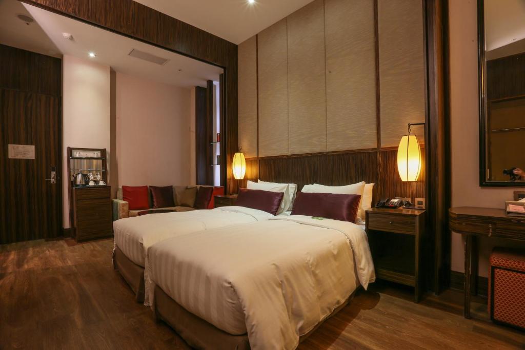 Postel nebo postele na pokoji v ubytování City Suites - Taipei Nandong