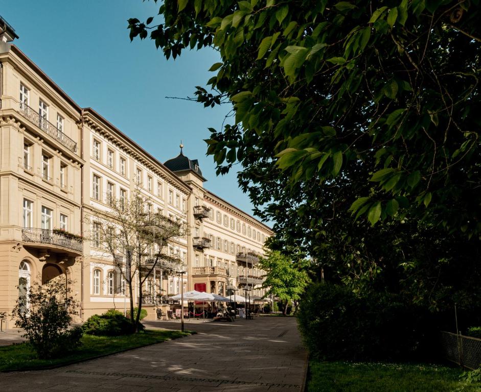 ein großes Gebäude mit einer Straße davor in der Unterkunft Kaiserhof Victoria in Bad Kissingen