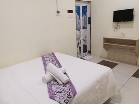 Postel nebo postele na pokoji v ubytování LH Hotel Langkap Perak