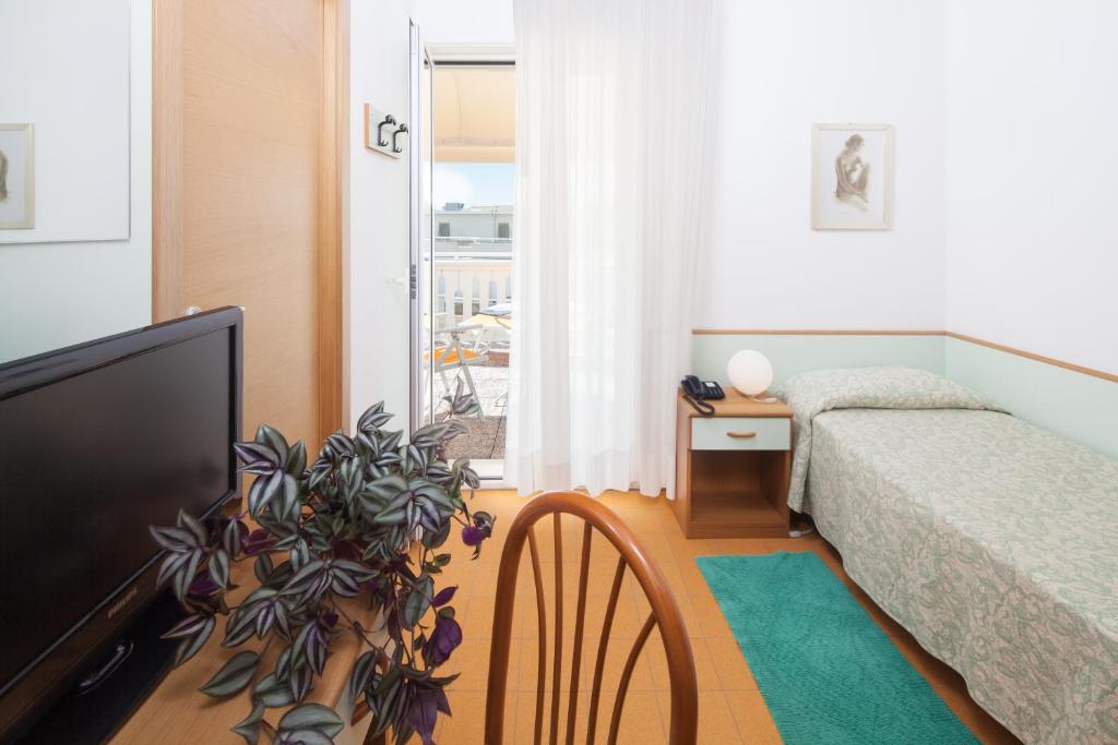 Postel nebo postele na pokoji v ubytování Hotel Universal