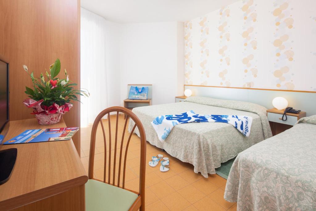 Postel nebo postele na pokoji v ubytování Hotel Universal