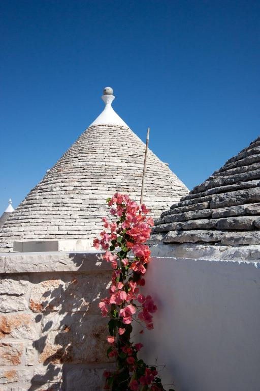 a bunch of flowers on the side of a building at Trullo Aprìco in Alberobello