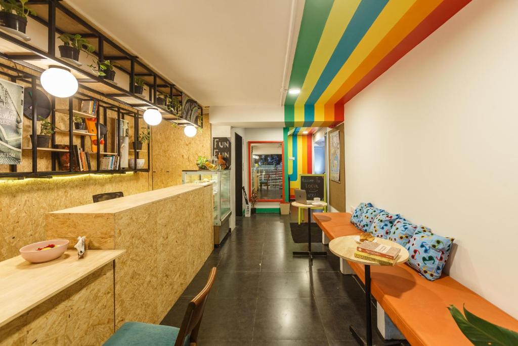a restaurant with a rainbow ceiling and tables and chairs at Locul Central - Church Street in Bangalore