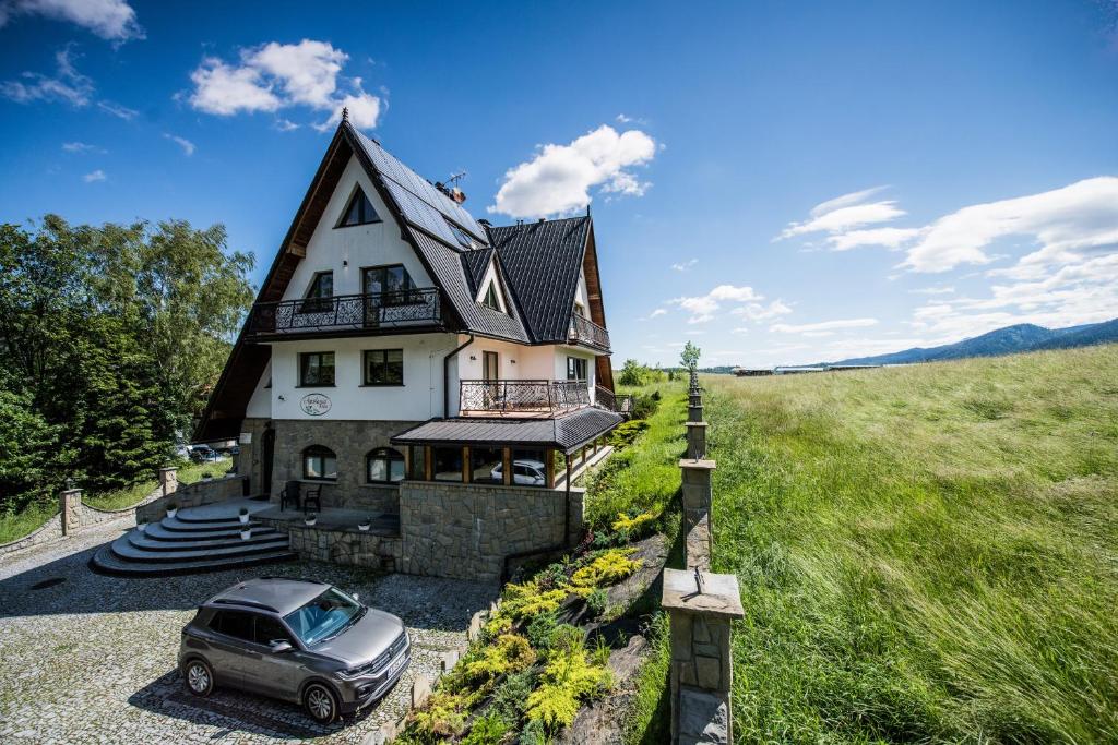 a car parked in front of a house at Apolonia Willa in Zakopane