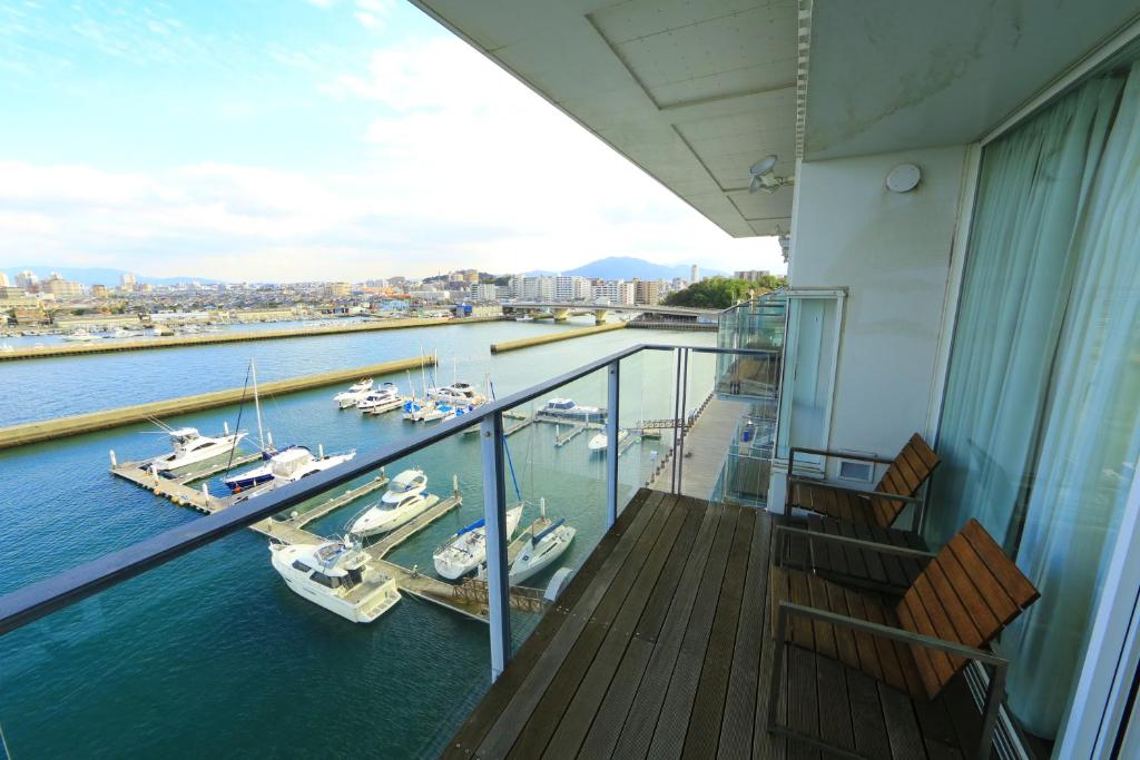 un balcone di una nave con barche in acqua di Hotel Marinoa Resort Fukuoka a Fukuoka