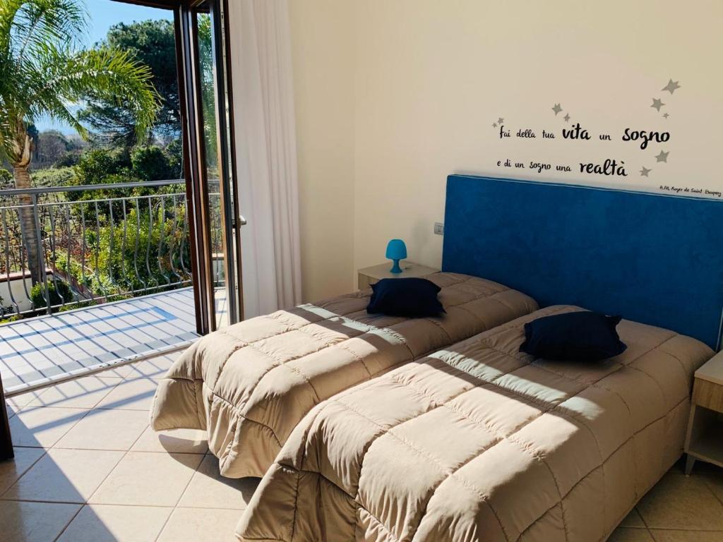 2 łóżka w pokoju z balkonem w obiekcie B&B Nonna Franca w mieście Trecase