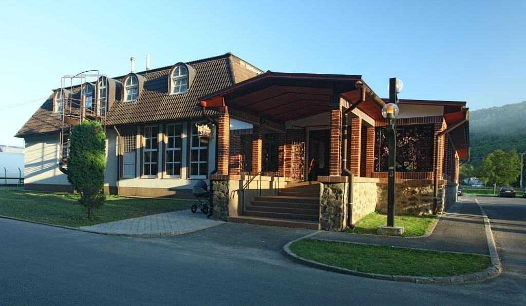 a house on the side of a street at Hotel Armales in Stakčín