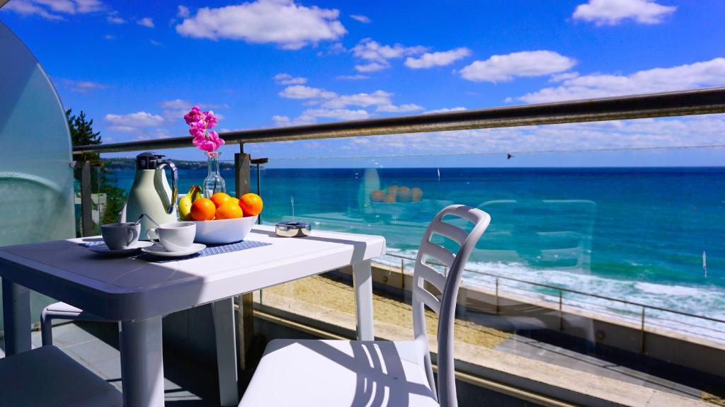 a table and chairs with a view of the ocean at Aurora apartments on the beach in Obzor
