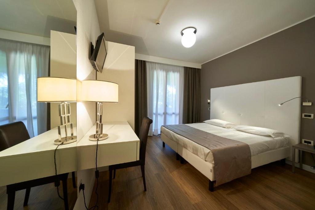 Postel nebo postele na pokoji v ubytování Park Hotel Chianti
