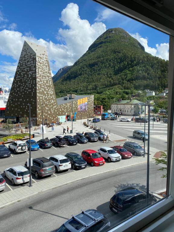 a view of a parking lot with cars parked at Åndalsnes Sentrum Apartment No1 in Åndalsnes