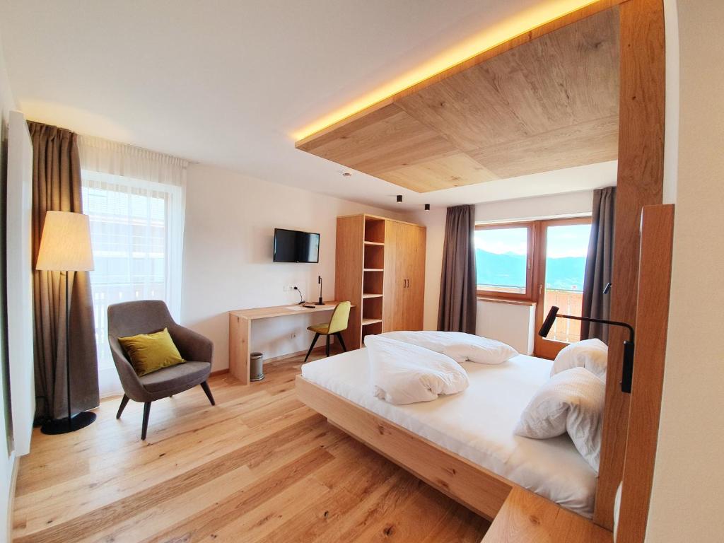 1 dormitorio con cama, escritorio y silla en Hotel Pfeiferhof, en Maranza
