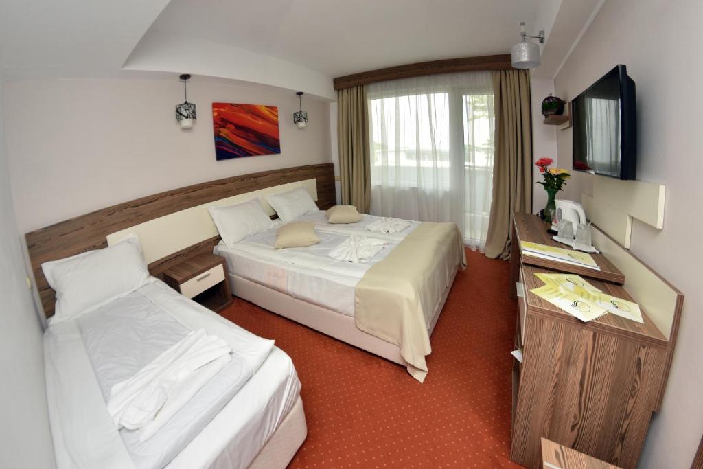 Postel nebo postele na pokoji v ubytování Hotel Olimpic