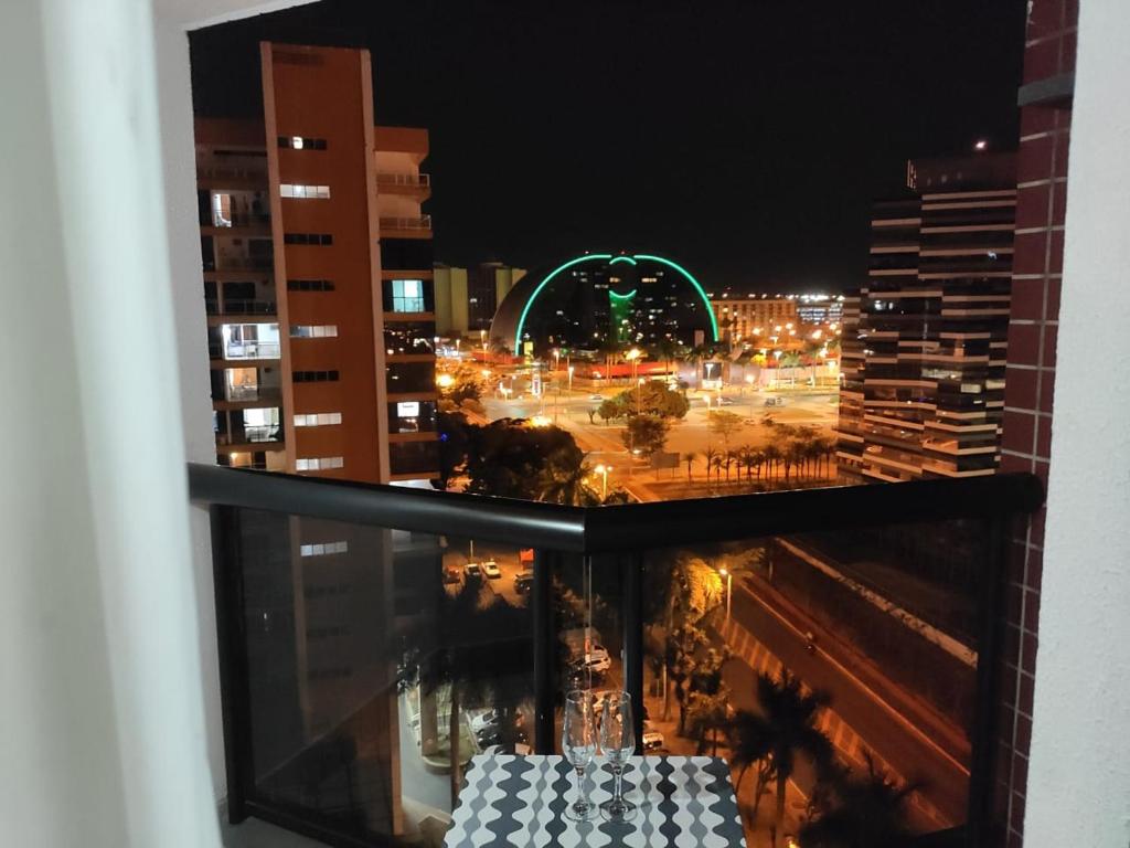 a view of a city at night from a window at Condomínio Metropolitan - Centro de Brasília A216A in Brasilia