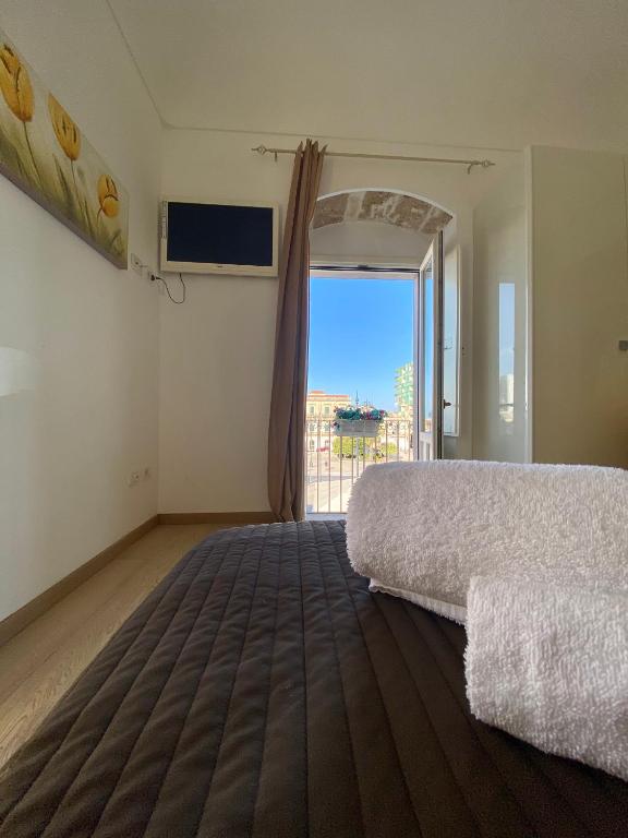 Postel nebo postele na pokoji v ubytování Plaza Rooms