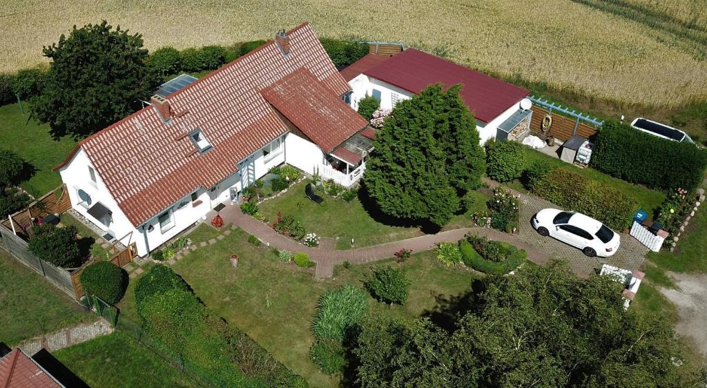 a house with a car parked in front of it at Fewo Steuerbord in Rambin