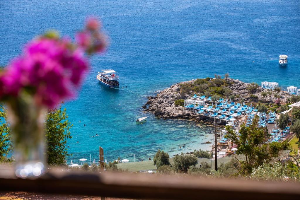 a view of a harbor with a boat in the water at Hamarat Otel in Kaş