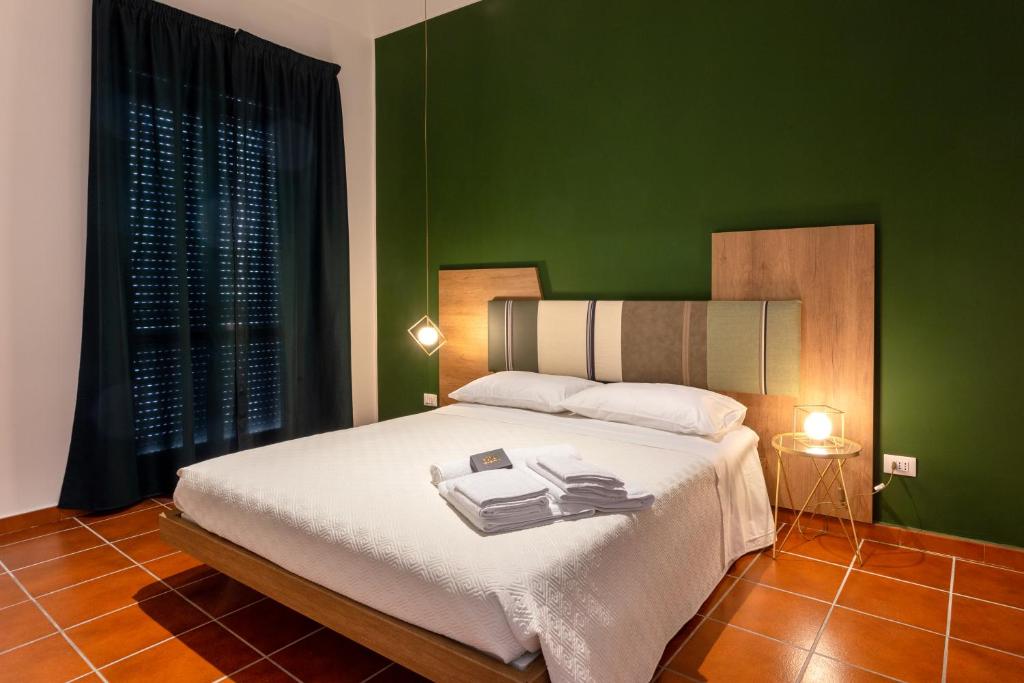 En eller flere senge i et værelse på Apollo Apartment Ortigia