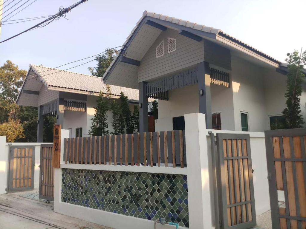 a house with a wooden fence in front of it at Origin hua hin poolvilla in Hua Hin