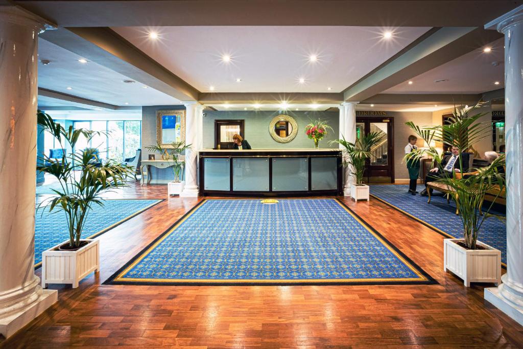 a lobby with a large rug on the floor at Greenhills Hotel Limerick in Limerick