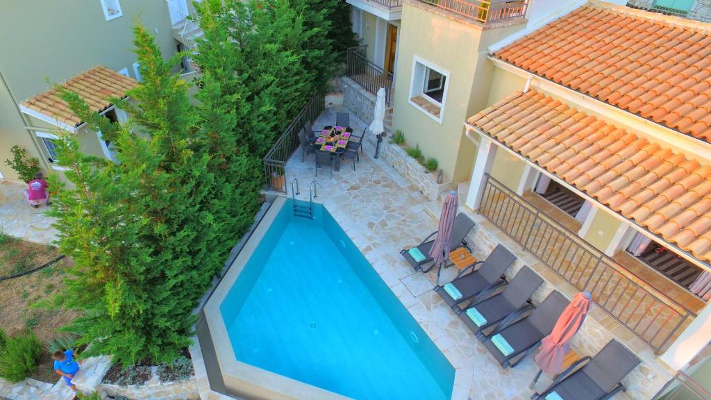 an overhead view of a swimming pool next to a house at The Cassius Hill House in Kassiopi