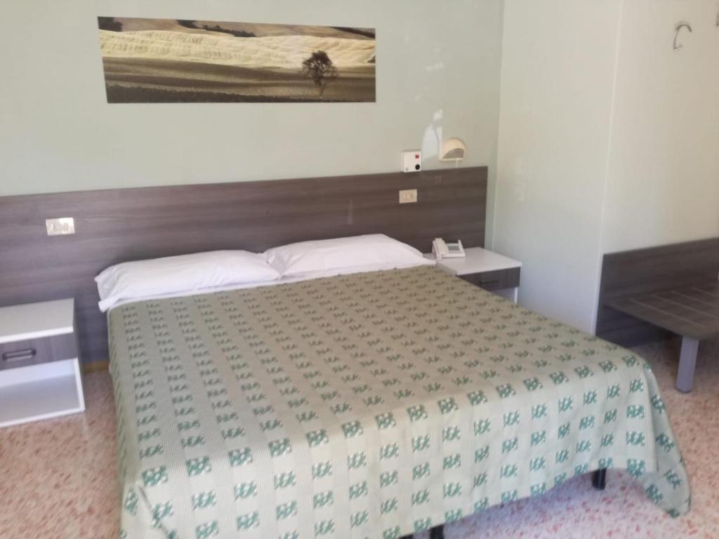 Postel nebo postele na pokoji v ubytování Hotel Saturno