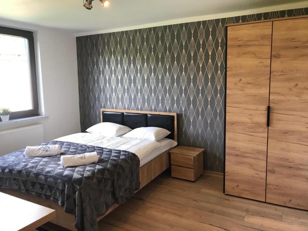 Postel nebo postele na pokoji v ubytování Loft Wisla Houses