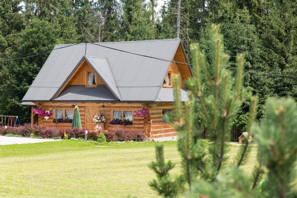 a log cabin with a metal roof at Domek góralski Toporówka in Murzasichle