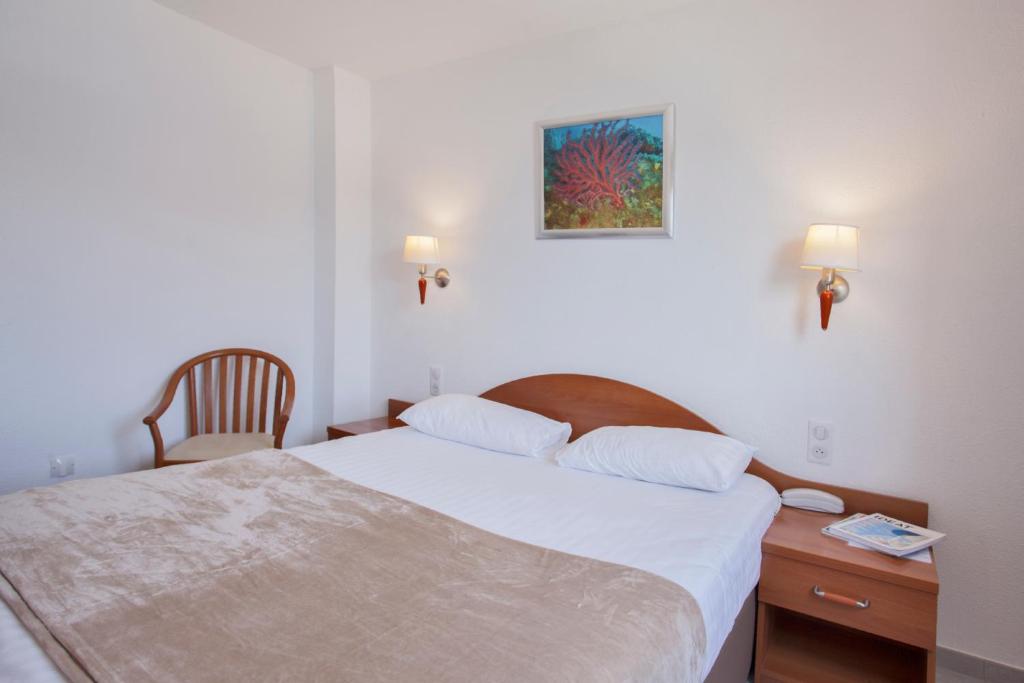 Postel nebo postele na pokoji v ubytování Le Neptune & Spa