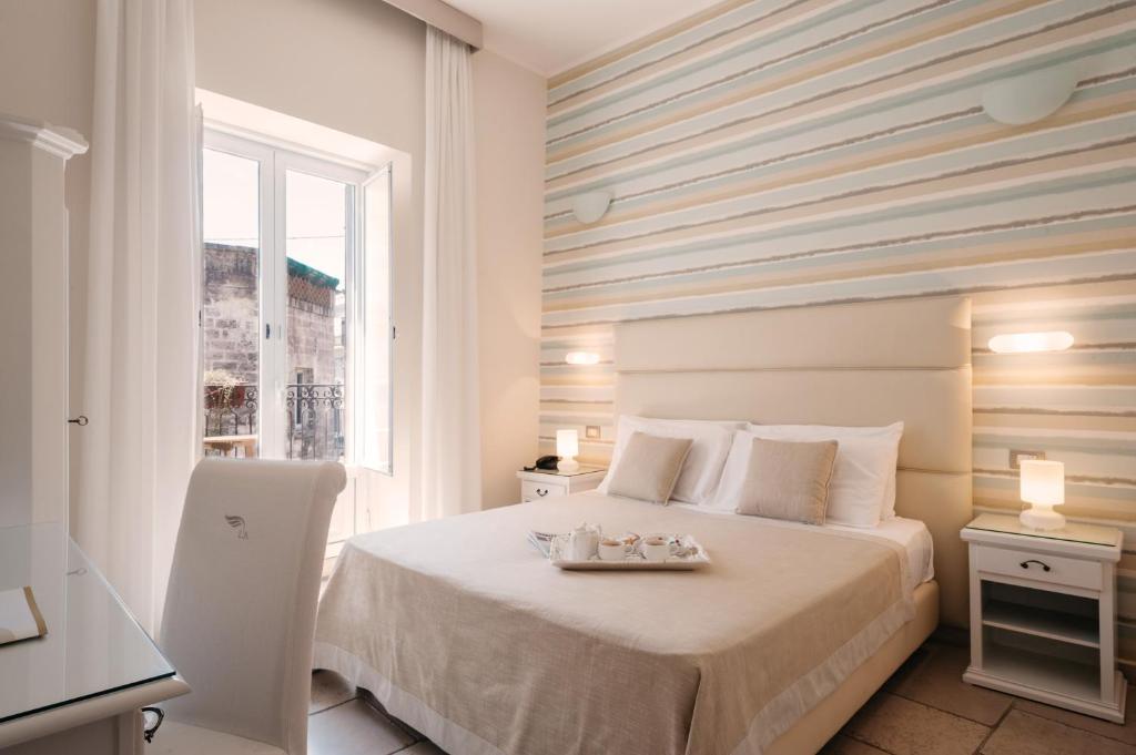 Postel nebo postele na pokoji v ubytování Hotel L'Arcangelo - Boutique Hotel