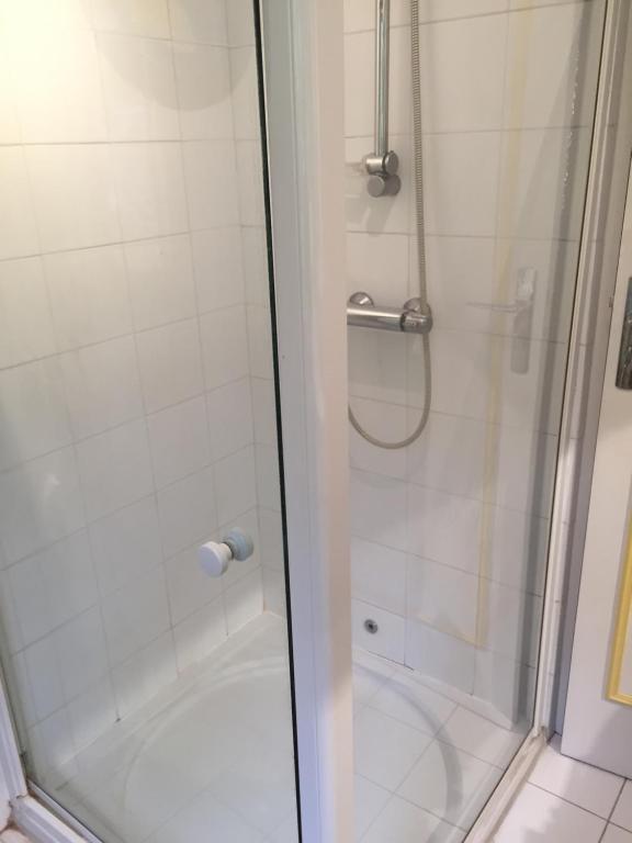 a shower with a glass door next to a tub at Villa Bellochio in Menton